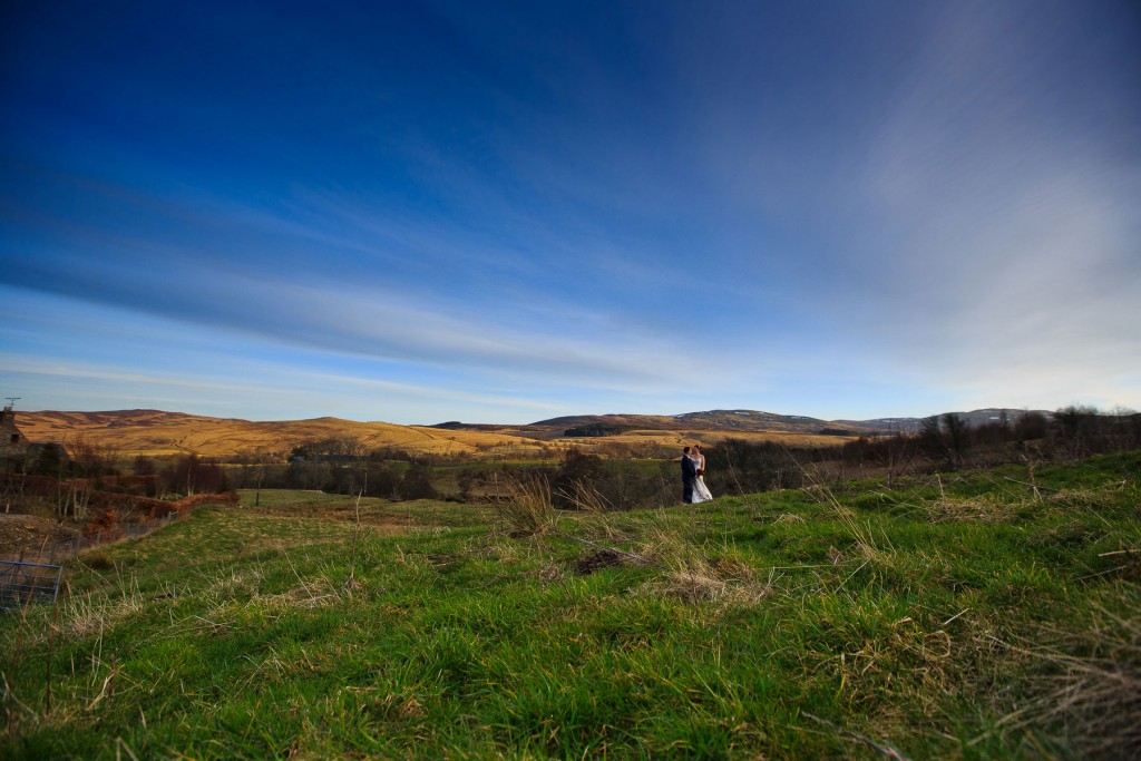 bride and groom in field